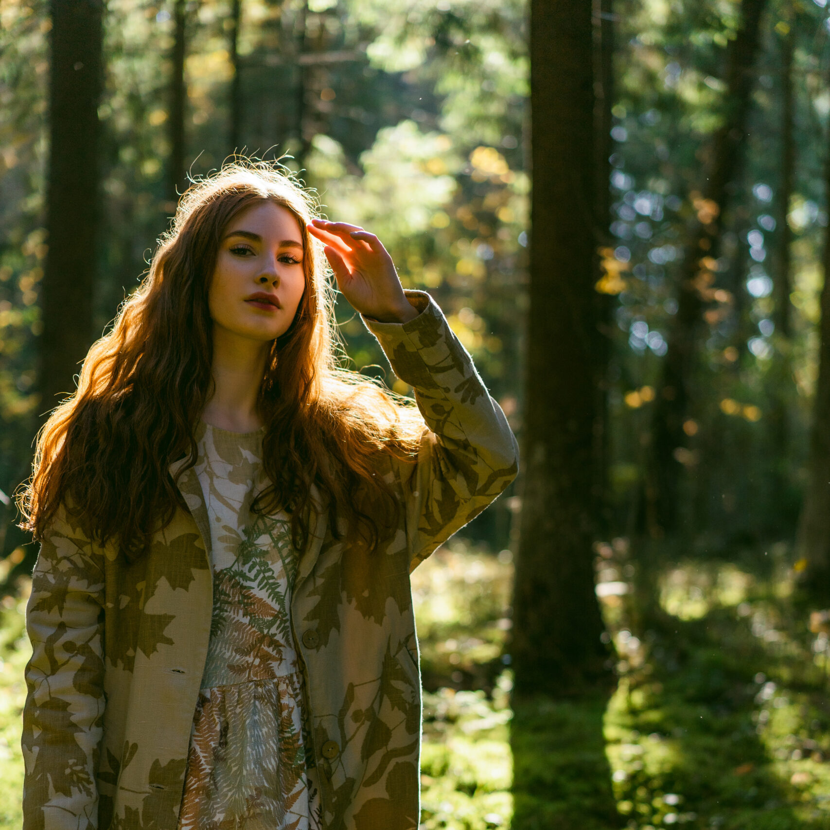 Young woman with long red hair in a linen dress gathering mushrooms in the forest in the bast basket